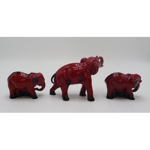 2151 - A ROYAL DOULTON FLAMBE MODEL OF AN ELEPHANT13cm high, together with two smaller groups of elephant a... 