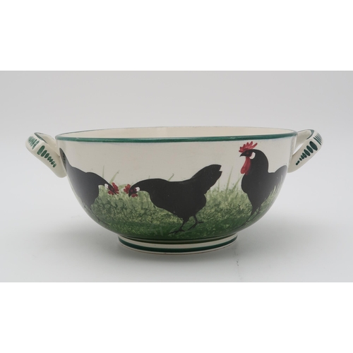 2167 - A WEMYSS TWO HANDLED POTTERY BOWLdecorated with a black cockerel and hens, printed Thomas Goode &... 