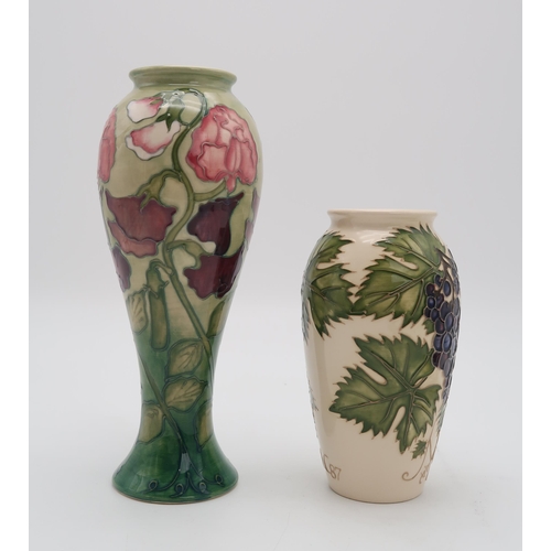 2180 - TWO MOORCROFT COLLECTORS CLUB PIECESincluding a Sweet Pea vase, 27.5cm high together with a Grapevin... 