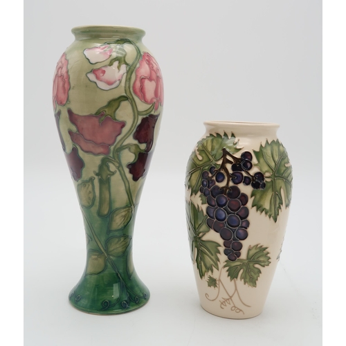 2180 - TWO MOORCROFT COLLECTORS CLUB PIECESincluding a Sweet Pea vase, 27.5cm high together with a Grapevin... 