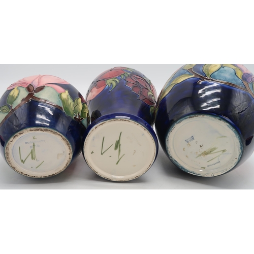 2183 - A COLLECTION OF MOORCROFT POTTERYincluding two Magnolia pattern ginger jars, one with an anemone pat... 