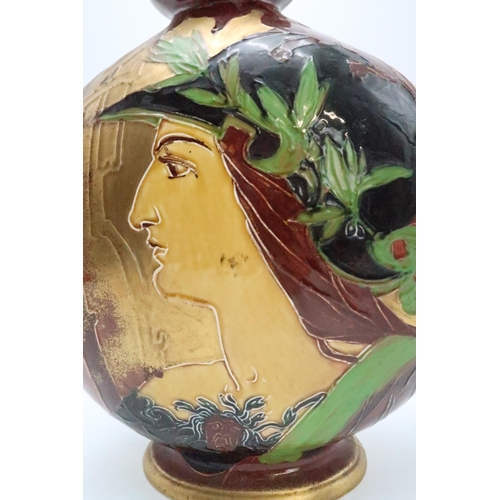 2185 - AN ENGLISH POTTERY MOON FLASKin the style of Thomas Forester, with tube line decoration of a woman, ... 