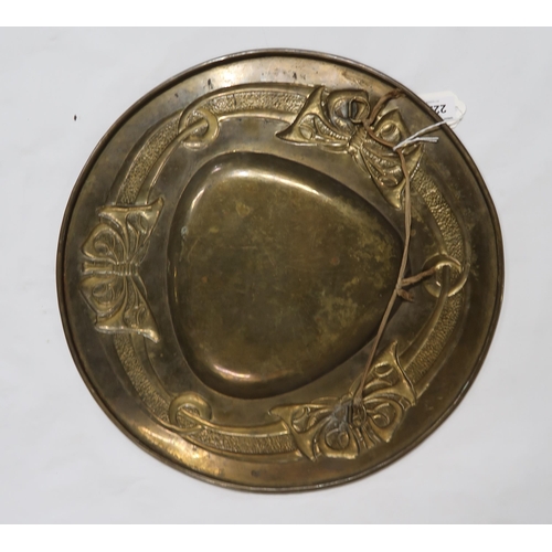 2225 - ATTRIBUTED TO MARGARET GILMOUR (1863-1942)Glasgow School, a brass charger embossed in low relief wit... 