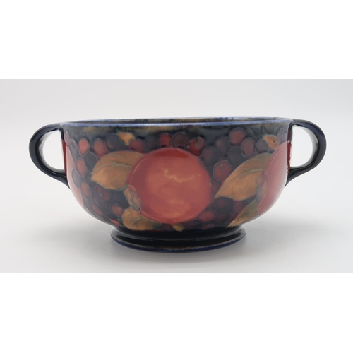 2238 - A MOORCROFT LEAF AND BERRY FLAMBE PATTERN DISHraised on a pedestal, blue signature to base and impre... 