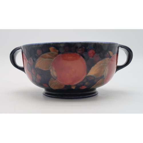 2238 - A MOORCROFT LEAF AND BERRY FLAMBE PATTERN DISHraised on a pedestal, blue signature to base and impre... 