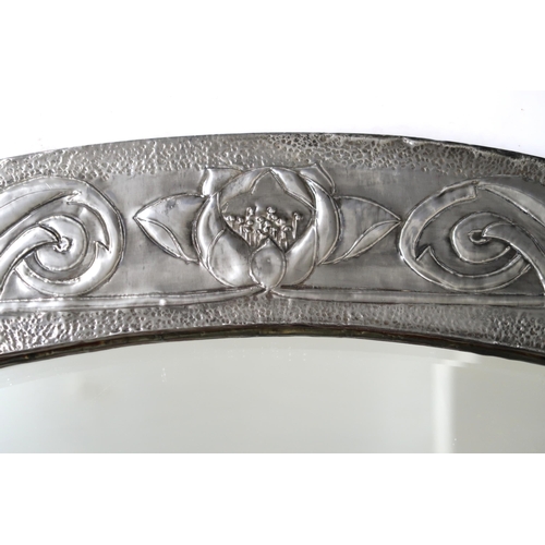 2239 - A GLASGOW SCHOOL ARTS AND CRAFTS PEWTER FRAMED MIRRORof oval shape with relief decoration of flowers... 