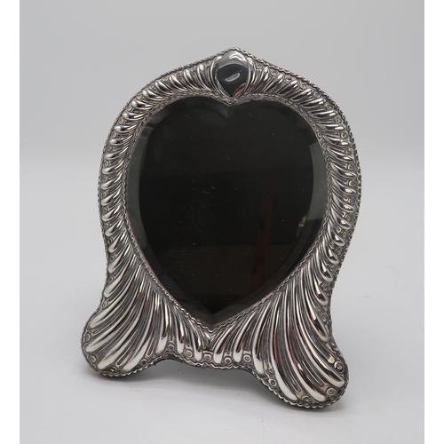 2406 - A LATE VICTORIAN SILVER FRAMED HEART-SHAPED MIRRORby William Comyns, London 1896, the fluted frame w... 