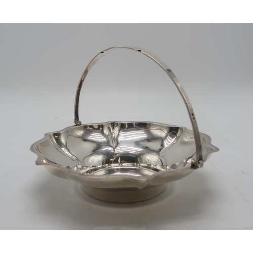 2412 - A GEORGE V SILVER SWING-HANDLED BASKETby Cooper Brothers & Sons, Sheffield 1927, of lobed form, ... 