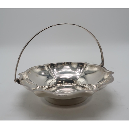 2412 - A GEORGE V SILVER SWING-HANDLED BASKETby Cooper Brothers & Sons, Sheffield 1927, of lobed form, ... 