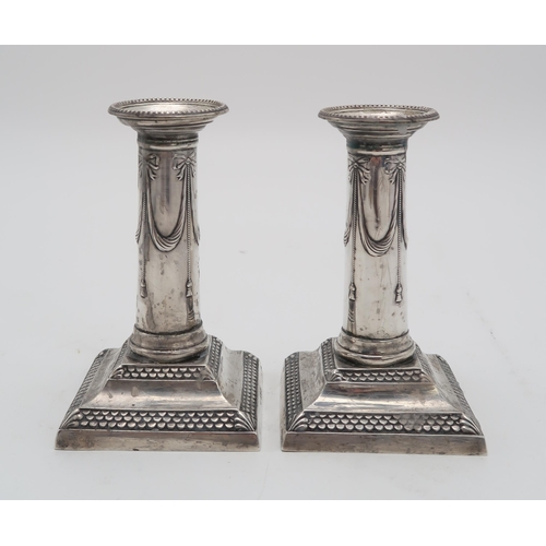 2423 - A PAIR OF LATE VICTORIAN SILVER CANDLESTICKSby Thomas Bradbury, London 1899, of column form, with sw... 