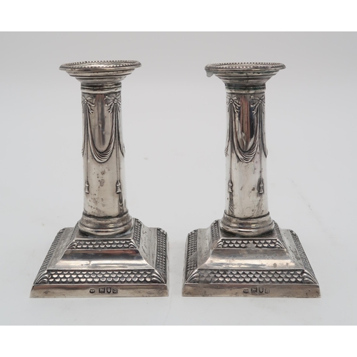 2423 - A PAIR OF LATE VICTORIAN SILVER CANDLESTICKSby Thomas Bradbury, London 1899, of column form, with sw... 