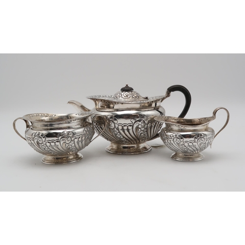 2440 - AN EDWARDIAN THREE PIECE SILVER TEA SERVICEby Atkins Brothers, Sheffield 1904, of squat form, with e... 