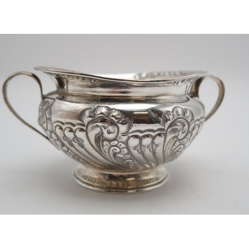 2440 - AN EDWARDIAN THREE PIECE SILVER TEA SERVICEby Atkins Brothers, Sheffield 1904, of squat form, with e... 