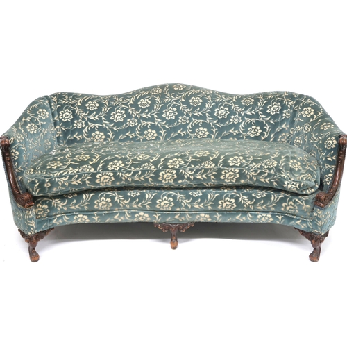2018 - A VICTORIAN WALNUT FRAMED HUMPBACK SETTEE with floral upholstery, scrolled acanthus carved arms on c... 