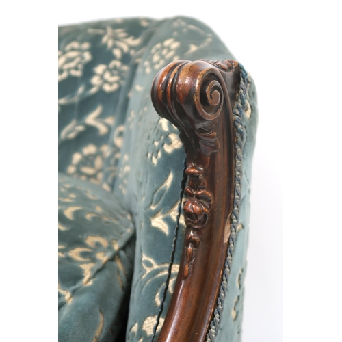 2018 - A VICTORIAN WALNUT FRAMED HUMPBACK SETTEE with floral upholstery, scrolled acanthus carved arms on c... 