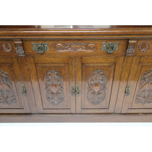 2035 - A LATE VICTORIAN STAINED OAK ARTS & CRAFTS MIRROR BACKED SIDEBOARD with scrolled surmount over m... 