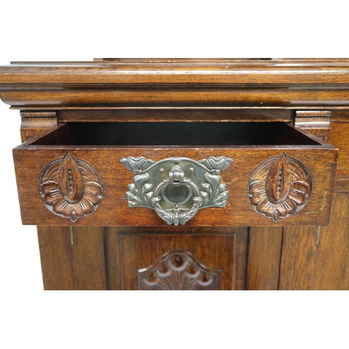 2035 - A LATE VICTORIAN STAINED OAK ARTS & CRAFTS MIRROR BACKED SIDEBOARD with scrolled surmount over m... 