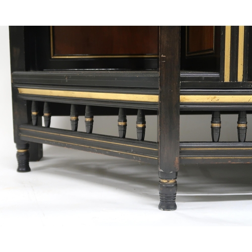 2038 - A VICTORIAN AESTHETIC MOVEMENT EBONISED AND GILT CABINET shaped top with moulded cornice over single... 