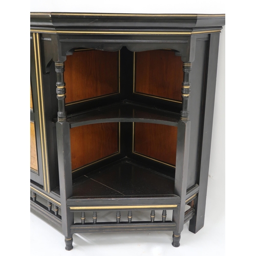 2038 - A VICTORIAN AESTHETIC MOVEMENT EBONISED AND GILT CABINET shaped top with moulded cornice over single... 