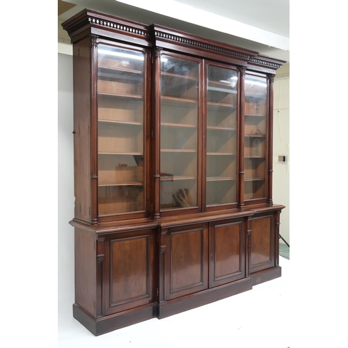 2039 - A LARGE VICTORIAN MAHOGANY BREAKFRONT LIBRARY BOOKCASE with moulded dentil cornice over pair of cent... 