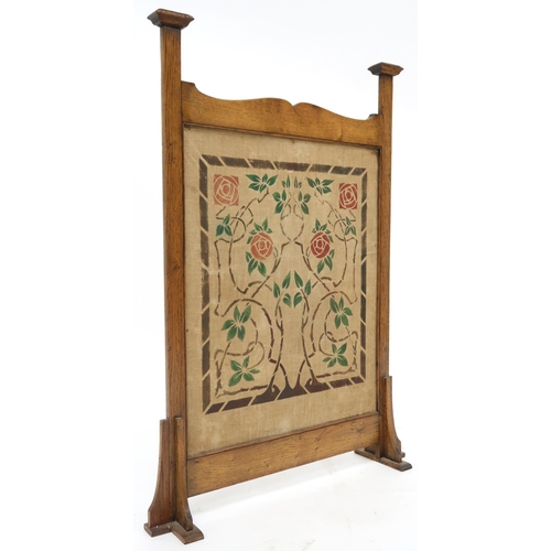 2045 - A LATE VICTORIAN OAK FRAMED GLASGOW STYLE FIRE SCREEN with central panel decorated with floral and f... 