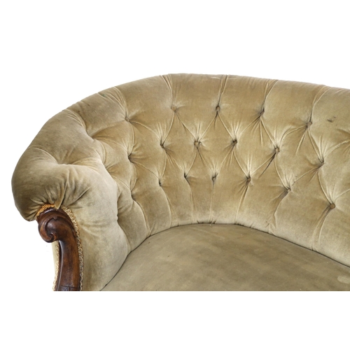 2046 - A VICTORIAN WALNUT FRAMED BUTTON BACK UPHOLSTERED SETTEE with carved scrolled front supports termina... 