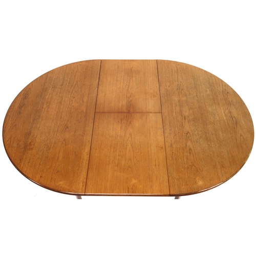 2102 - A MID 20TH CENTURY TEAK EXTENDING DINING TABLE AND SIX CHAIRS with circular extending top over inter... 