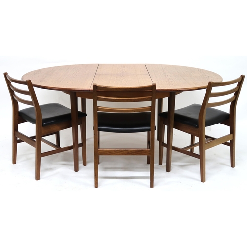 2102 - A MID 20TH CENTURY TEAK EXTENDING DINING TABLE AND SIX CHAIRS with circular extending top over inter... 