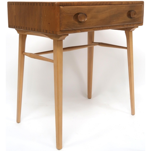 2108 - A MID 20TH CENTURY ERCOL ELM AND BEECH WRITING TABLE rectangular top with single drawer with shaped ... 
