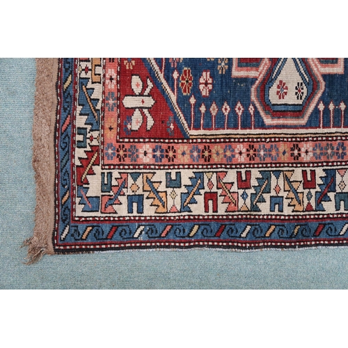 2130 - A BLUE GROUND CAUCASIAN KAZAK RUG with three red and beige medallions on geometric pattern ground wi... 