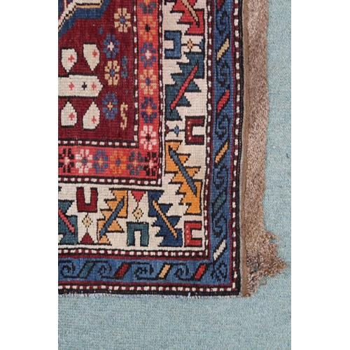 2130 - A BLUE GROUND CAUCASIAN KAZAK RUG with three red and beige medallions on geometric pattern ground wi... 