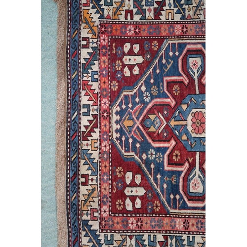 2130 - A BLUE GROUND CAUCASIAN KAZAK RUG with three red and beige medallions on geometric pattern ground wi... 