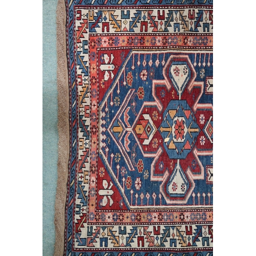 2130 - A BLUE GROUND CAUCASIAN KAZAK RUG with three red and beige medallions on geometric pattern ground wi... 