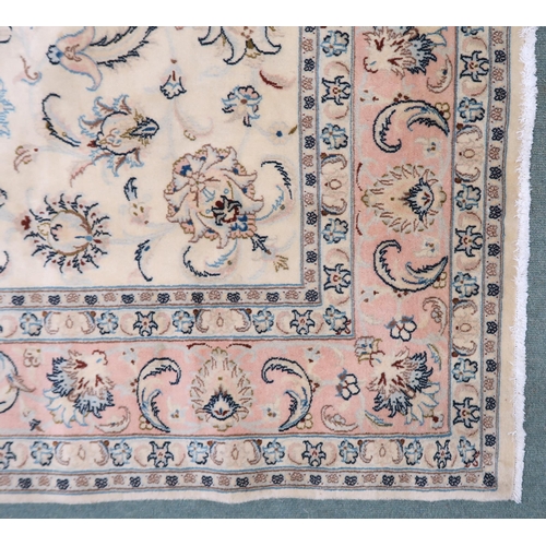 2132 - A CREAM GROUND FINE KASHAN RUG with all-over floral patterned ground and light pink flower head bord... 