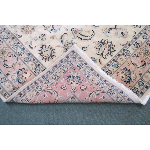 2132 - A CREAM GROUND FINE KASHAN RUG with all-over floral patterned ground and light pink flower head bord... 