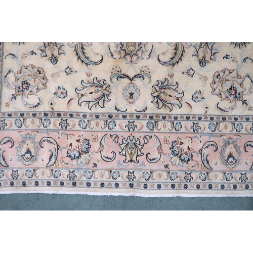 2132 - A CREAM GROUND FINE KASHAN RUG with all-over floral patterned ground and light pink flower head bord... 