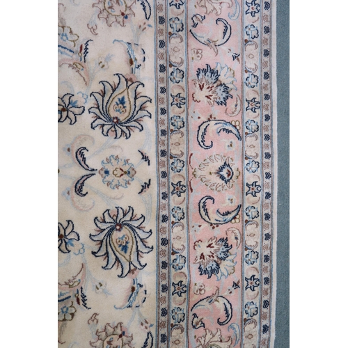 2132 - A CREAM GROUND FINE KASHAN RUG with all-over floral patterned ground and light pink flower head bord... 