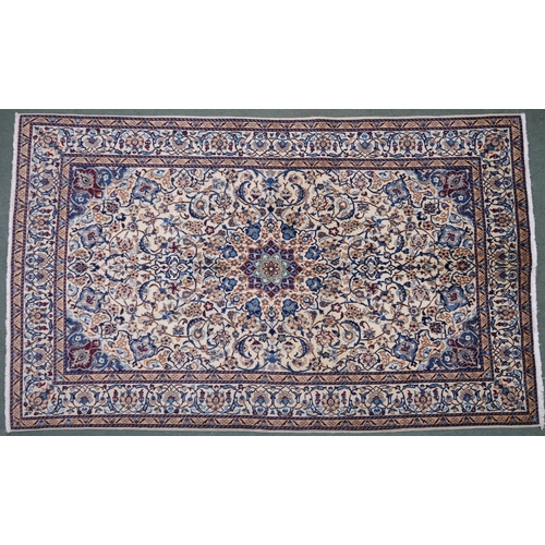 2134 - A CREAM GROUND NAIN RUG with a blue and red central medallion, matching spandrels on all-over floral... 