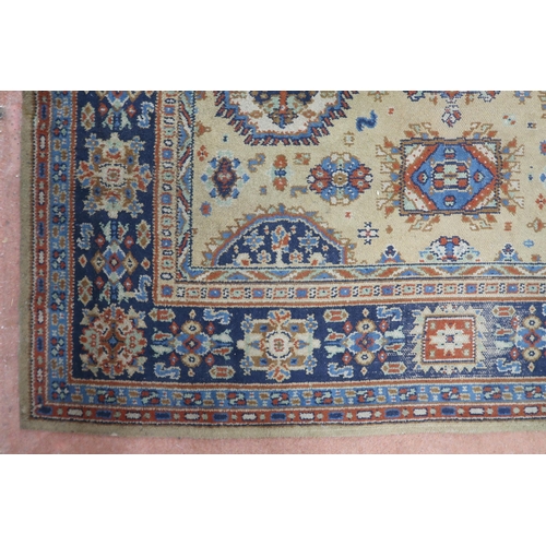 2140 - A LARGE BEIGE GROUND JAMES TEMPLETON & CO LTD STYLE RUG with all-over multicoloured lozenge desi... 