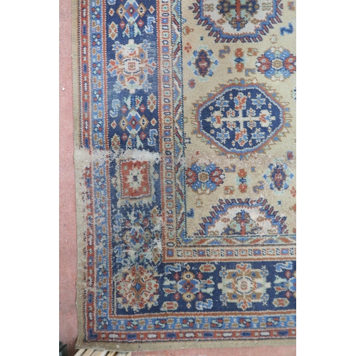 2140 - A LARGE BEIGE GROUND JAMES TEMPLETON & CO LTD STYLE RUG with all-over multicoloured lozenge desi... 