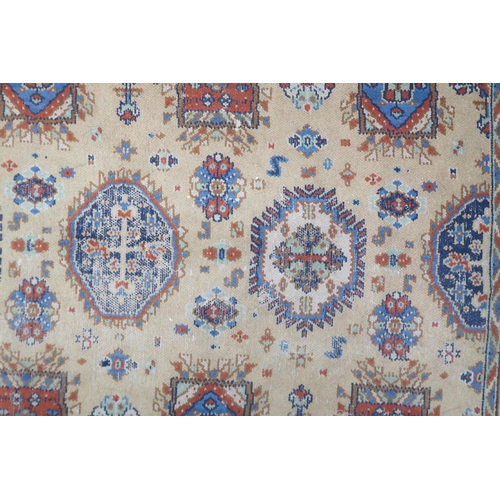 2140 - A LARGE BEIGE GROUND JAMES TEMPLETON & CO LTD STYLE RUG with all-over multicoloured lozenge desi... 