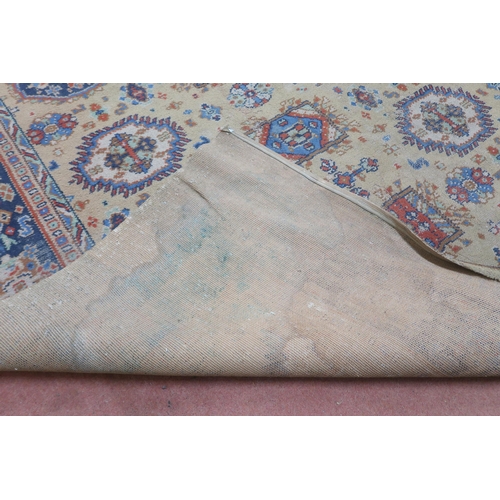 2140 - A LARGE BEIGE GROUND JAMES TEMPLETON & CO LTD STYLE RUG with all-over multicoloured lozenge desi... 