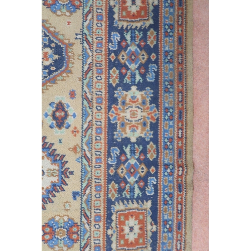 2140 - A LARGE BEIGE GROUND JAMES TEMPLETON & CO LTD STYLE RUG with all-over multicoloured lozenge desi... 