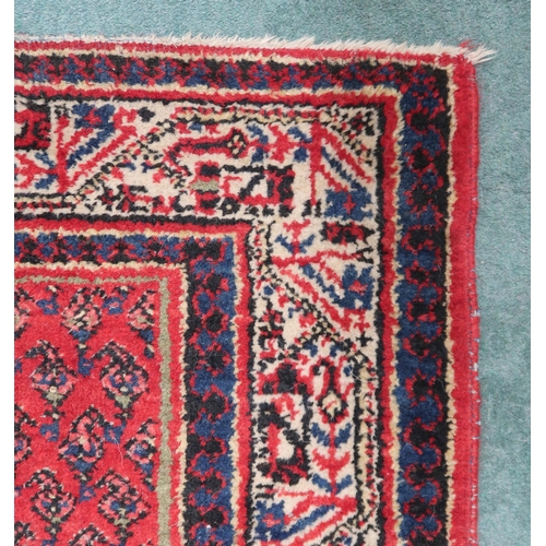 2142 - A RED GROUND ARAAK RUNNER with geometric multicoloured borders, 216cm long x 95cm wide... 