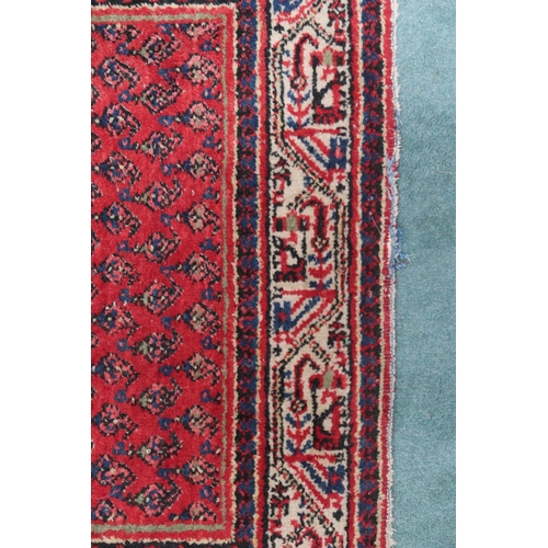 2142 - A RED GROUND ARAAK RUNNER with geometric multicoloured borders, 216cm long x 95cm wide... 