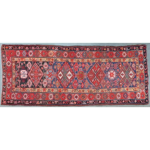 2143 - A DARK BLUE GROUND CAUCASIAN RUNNER with four multicoloured diamond medallions and multicoloure... 