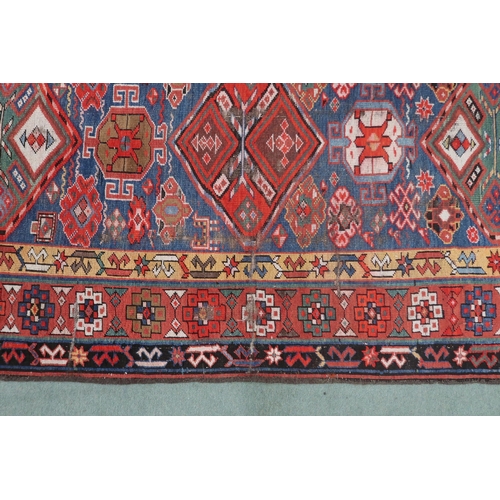 2143 - A DARK BLUE GROUND CAUCASIAN RUNNER with four multicoloured diamond medallions and multicoloure... 