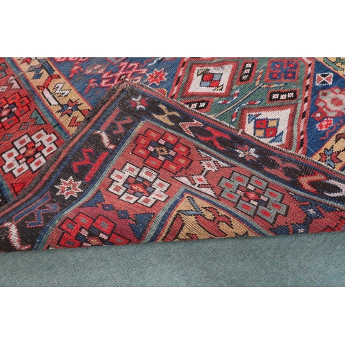 2143 - A DARK BLUE GROUND CAUCASIAN RUNNER with four multicoloured diamond medallions and multicoloure... 