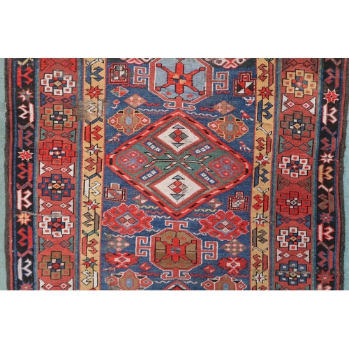 2143 - A DARK BLUE GROUND CAUCASIAN RUNNER with four multicoloured diamond medallions and multicoloure... 