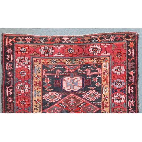 2143 - A DARK BLUE GROUND CAUCASIAN RUNNER with four multicoloured diamond medallions and multicoloure... 